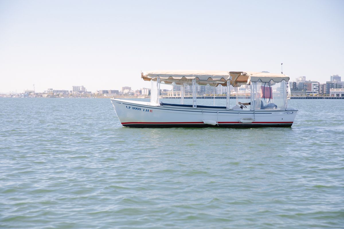 The fully enclosed Duffy Old Bay electric boat cruising in Alameda
