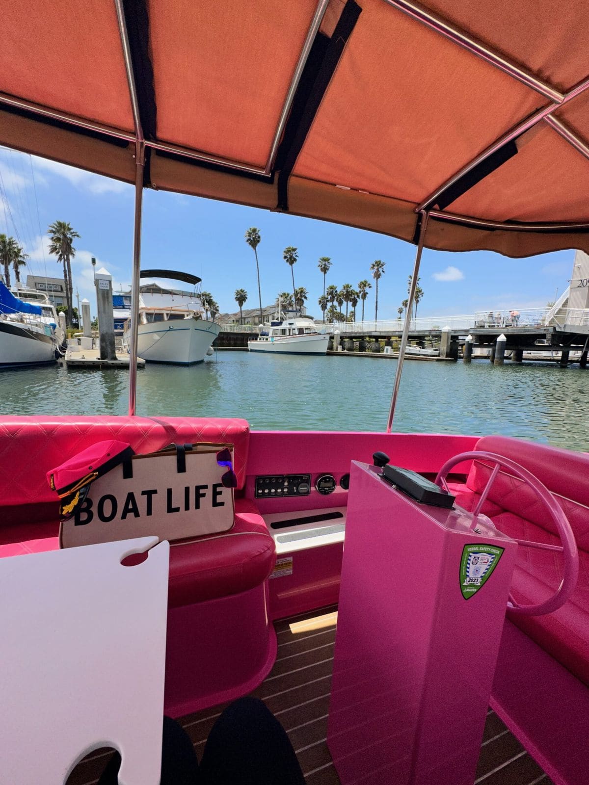 The pink Fantail electric boat dressed for a celebration at Grand Marina in Alameda