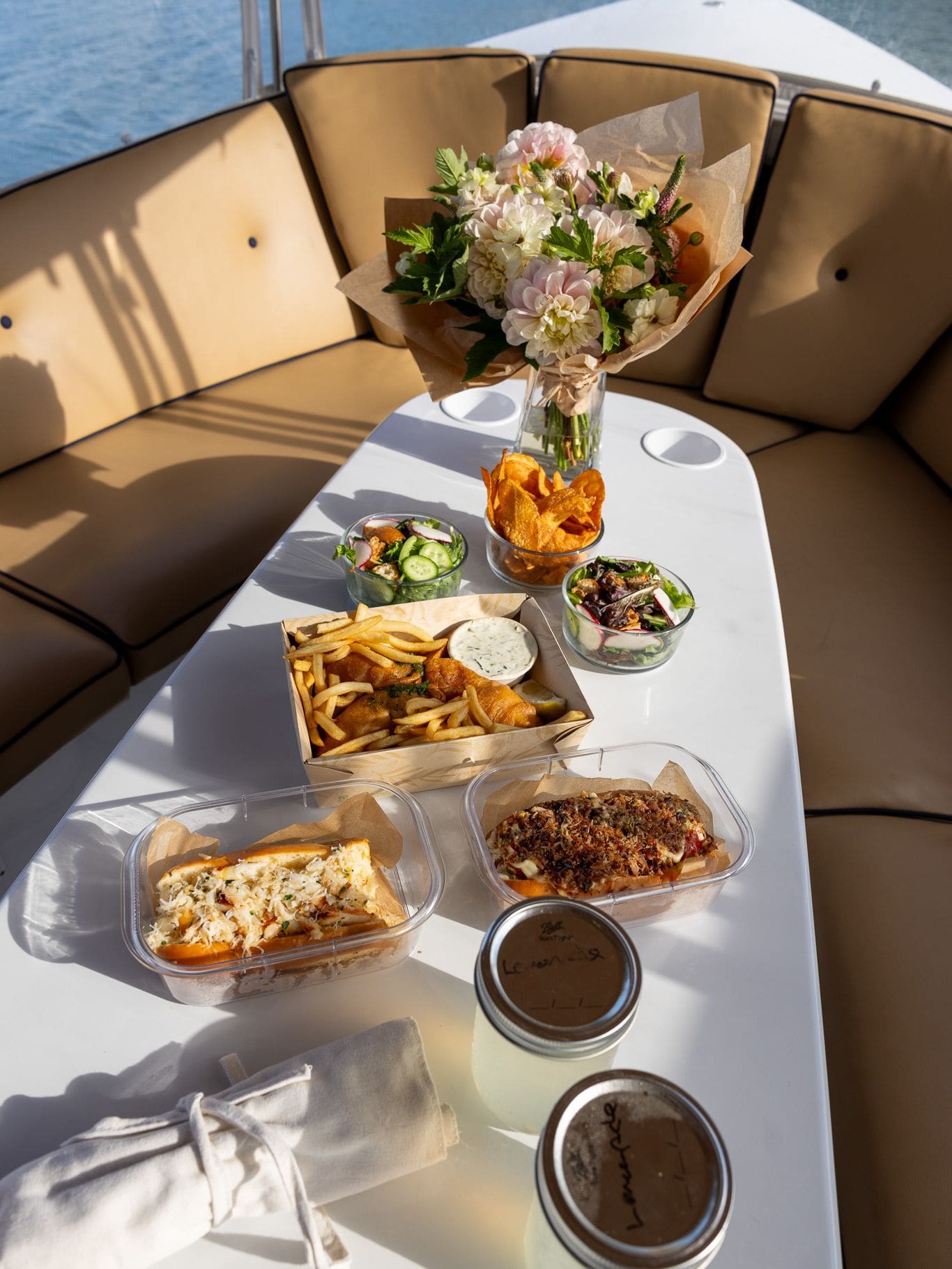 A charcuterie and picnic spread laid out on the table of a Bae Boats electric boat