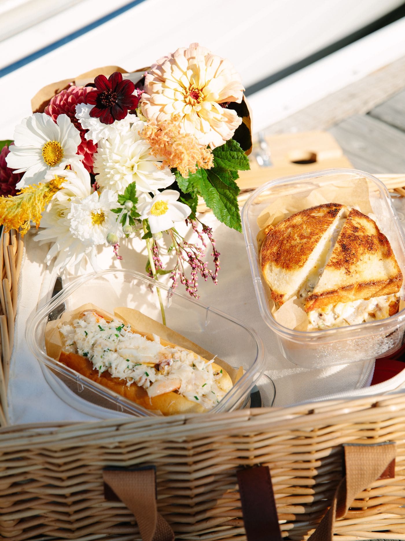 A charcuterie and picnic spread from a Bae Boats local partner laid out on a boat table